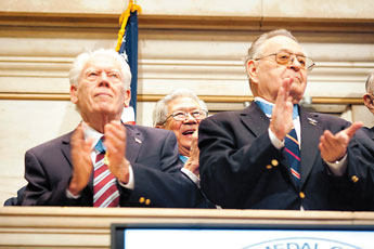 Medal of Honor recipient Hershey Miyamura, center, is photographed inside the New York Stock Exchange during a ceremony in which 30 Medal of Honor recipients ring the closing bell in New York, NY on March 22nd, 2011. Ramsay de Give for The Gallup Independent